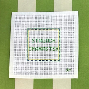 May include: Square needlepoint canvas with the words "STAUNCH CHARACTER" in green letters within a green, yellow, and blue border. The canvas is white with small holes, and the background is a green and white striped pattern.