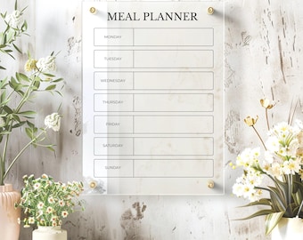 May include: A clear acrylic meal planner with a white background and black text. The planner has spaces for each day of the week, Monday through Sunday.