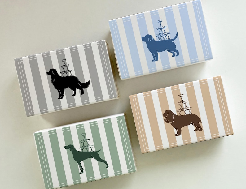 May include: Four rectangular boxes with vertical stripes in gray, blue, tan, and green. Each box features a silhouette of a dog carrying a stack of champagne glasses. The boxes are likely for gifts or small items.