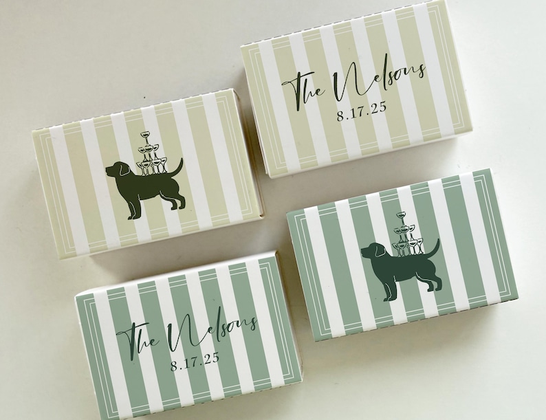May include: Four rectangular boxes with a striped pattern in green and white. Two boxes have a dog silhouette carrying a champagne glass tower. The other two boxes have the text "The Nelsons" and the date "8.17.25".