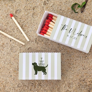 May include: Matchbox with red-tipped matches, and a second matchbox with a dog silhouette carrying champagne glasses. The matchboxes have a striped design with the text "The Nelsons 8.17.25".