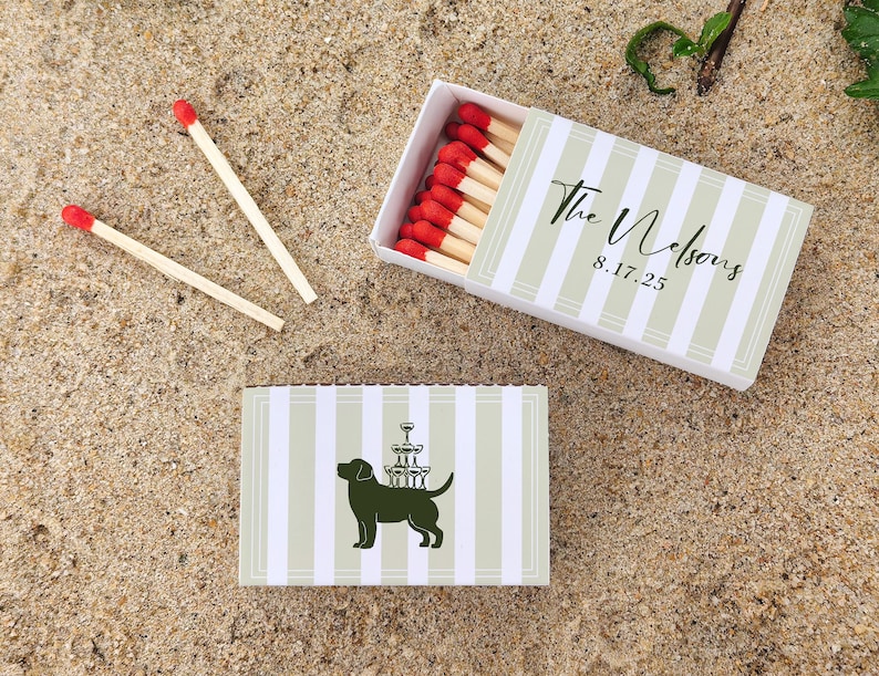 May include: Matchbox with red-tipped matches, and a second matchbox with a dog silhouette carrying champagne glasses. The matchboxes have a striped design with the text "The Nelsons 8.17.25".