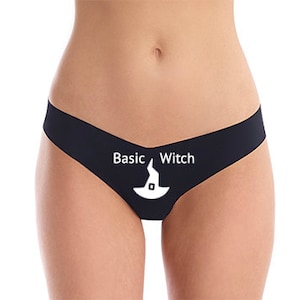 May include: Black lace thong underwear with the text "Basic Witch" and a witch's hat graphic.