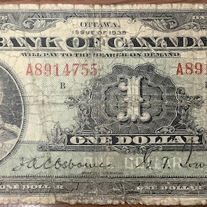 Może przedstawiać: Kanadyjski banknot jednodolarowy z 1938 roku z portretem króla Jerzego VI i tekstem "Bank of Canada".