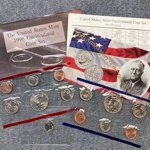 May include: A 1996 United States Mint Uncirculated Coin Set in a clear plastic bag. The coins are arranged in rows and include a penny, nickel, dime, quarter, and half dollar. The coins are all in pristine condition and have a shiny, metallic finish. The set is packaged in a clear plastic bag with a red and blue border. The bag is sealed with a sticker that says "1996 Uncirculated Coin Set".