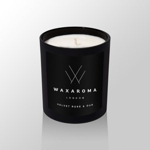 May include: Black candle jar with a white wax top and a white label that says "WAXAROMA LONDON VELVET ROSE & OUD".