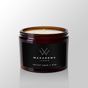 May include: A brown glass candle jar with a black label. The label has a white logo and the text "WAXAROMA LONDON VELVET ROSE & OUD".