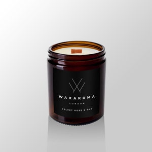 May include: A brown glass candle jar with a black label. The label has a white logo and the text "WAXAROMA LONDON VELVET ROSE & OUD".