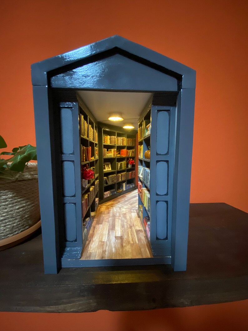 Mirror in the back create depth inside the cozy library scene.