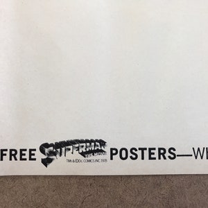 Może przedstawiać: Czarno-biały plakat z tekstem "FREE SUPERMAN THE MOVIE POSTERS - When You Buy..." i logo Supermana z tekstem "TM & &copy; DC COMICS INC 1978"