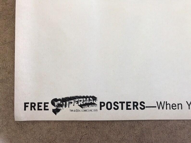 Może przedstawiać: Czarno-biały plakat z tekstem "FREE SUPERMAN THE MOVIE POSTERS - When You Buy..." i logo Supermana z tekstem "TM & &copy; DC COMICS INC 1978"