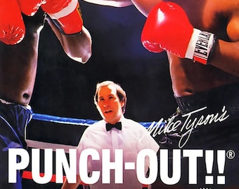 Op de afbeelding: Een videospelverpakking voor Mike Tyson's Punch-Out!! voor het Nintendo Entertainment System. De verpakking toont een bokswedstrijd tussen Mike Tyson en een andere bokser. De tekst op de verpakking luidt "Mike Tyson's Punch-Out!!" en "Vecht tegen Tyson in The Dream Bout. Daag boksers uit over de hele wereld uit. Win en word W.V.B.A.-kampioen."