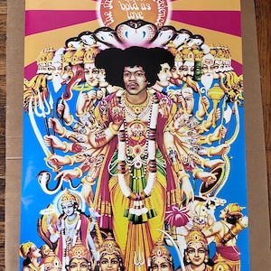 May include: A colourful poster depicting Jimi Hendrix as a Hindu deity with multiple arms. The poster is titled "The Jimi Hendrix Experience Axis: Bold as Love".