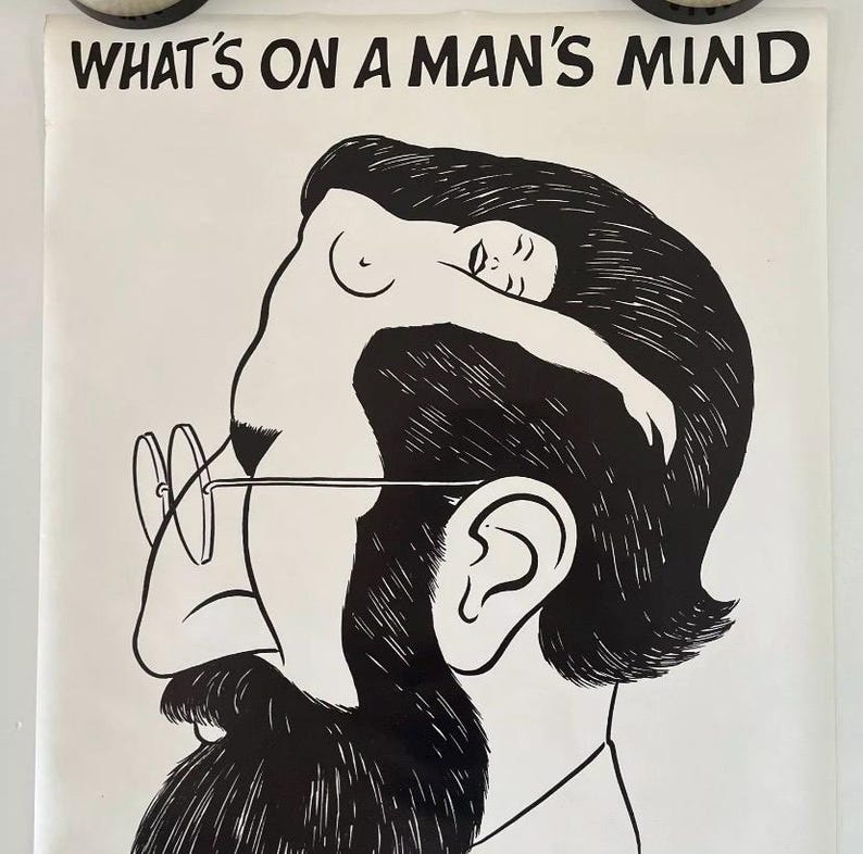 May include: Black and white poster with the text "WHAT'S ON A MAN'S MIND" at the top. The illustration depicts a man's head with a woman's silhouette inside. The man wears glasses and has a beard. The woman is nude.