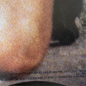May include: Close-up of a record label with the text "14-099 MARC SINGER AS DAR &copy; 1982 PRO ARTS, INC., MEDINA, OHIO, ALL RIGHTS RESE BEASTMASTER T.M. IS A TRADEMARK OF AND LICENSED BY LEISURE INVESTMEN"