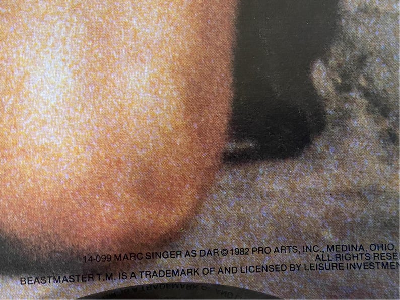 May include: Close-up of a record label with the text "14-099 MARC SINGER AS DAR &copy; 1982 PRO ARTS, INC., MEDINA, OHIO, ALL RIGHTS RESE BEASTMASTER T.M. IS A TRADEMARK OF AND LICENSED BY LEISURE INVESTMEN"