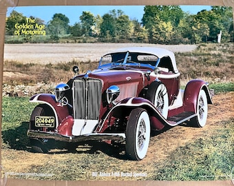 May include: A vintage maroon and white 1931 Auburn 8-88 Boattail Speedster, a classic car with a white convertible top, chrome accents, and a license plate that reads "204049".