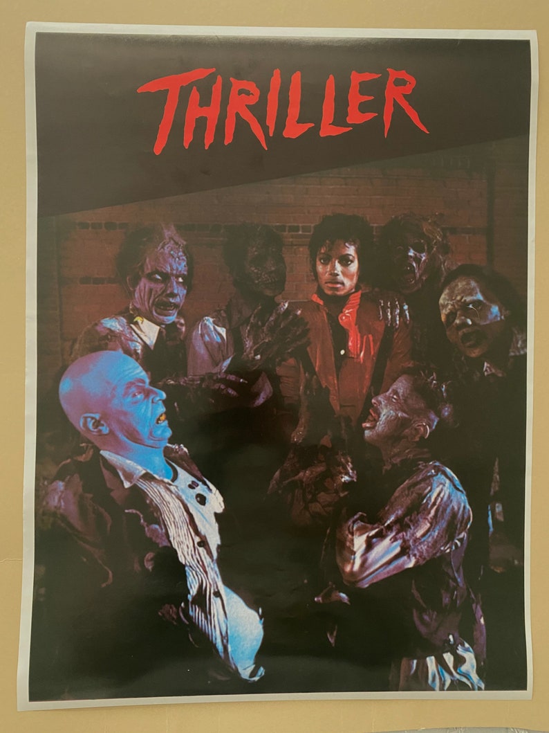 May include: A vintage poster for Michael Jackson's Thriller album. The poster features a black and white image of Michael Jackson and a group of zombies in a dark, shadowy setting. The word "Thriller" is written in red letters at the top of the poster.