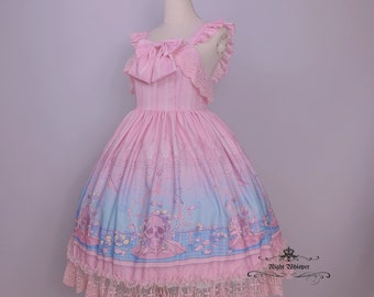 May include: A pink and blue lolita dress with a skull print and lace trim. The dress features a bow at the neckline and a tiered skirt.