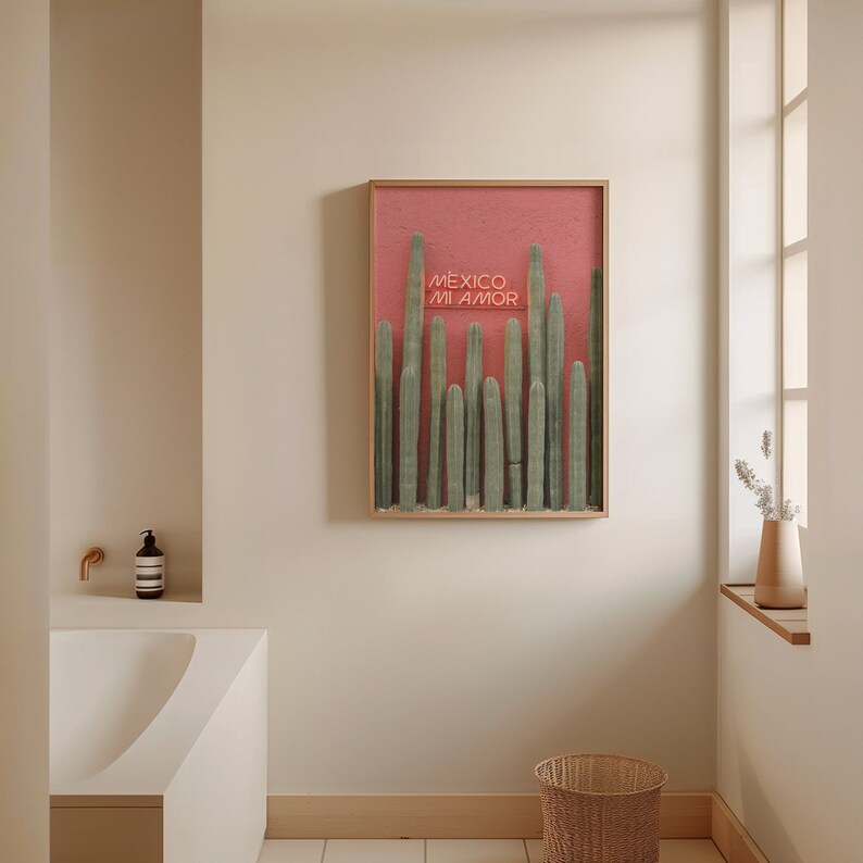 May include: A framed print with a pink background and a row of tall green cacti. The text "MEXICO MI AMOR" is written in pink letters on the print.