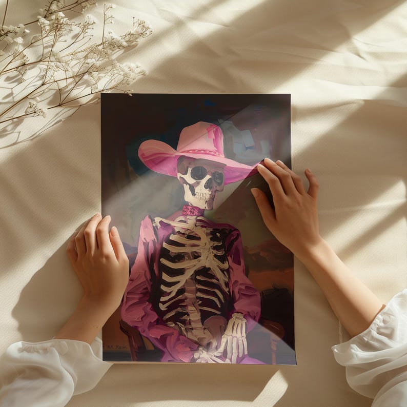 May include: A skeleton wearing a pink cowboy hat and a pink jacket. The skeleton is sitting in a chair with its hands resting on its lap.