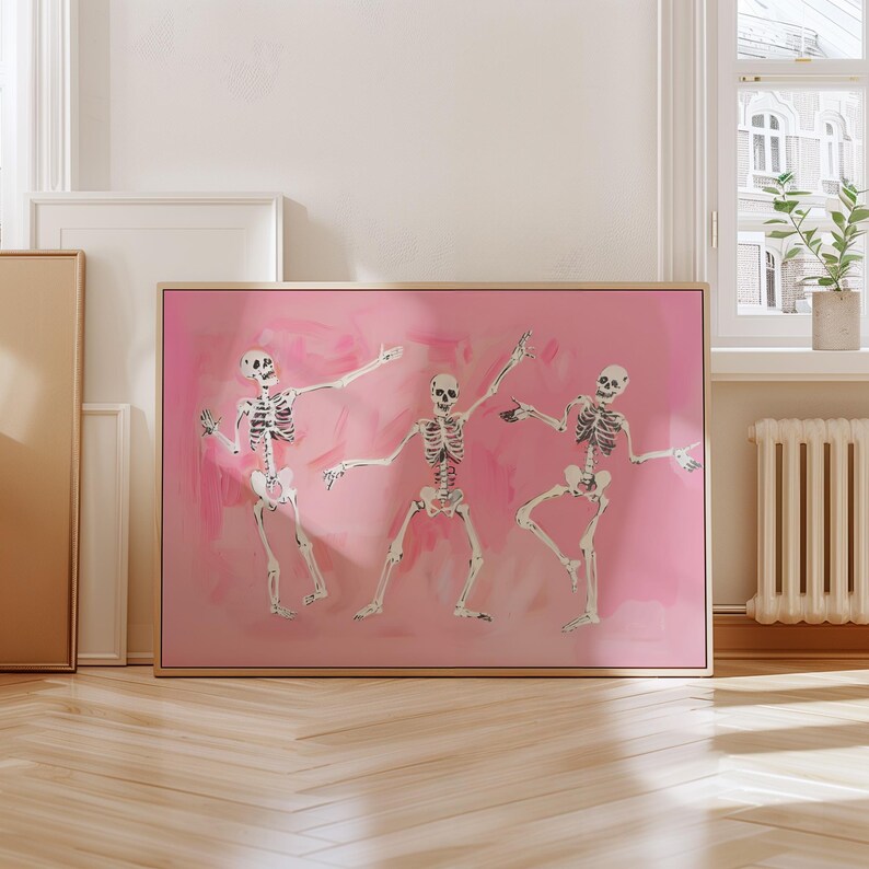 May include: Three skeletons dancing on a pink background. The skeletons are white and have black outlines. The skeletons are in different poses, with one skeleton holding its arms up in the air, one skeleton holding its arms out to the sides, and one skeleton holding its arms down by its sides.