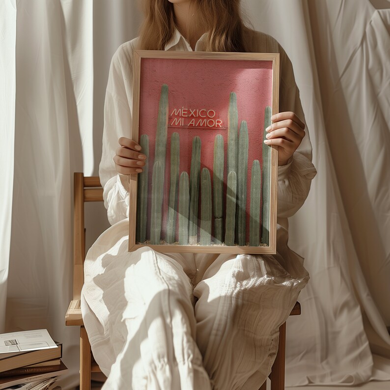 May include: A framed print with a pink background and a row of green cacti. The print has the text "Mexico Mi Amor" in white.