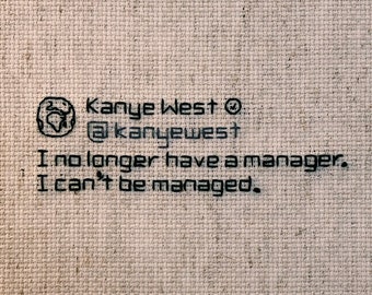 May include: A beige business card with black text that reads "Kanye West @kanyewest I no longer have a manager. I can't be managed."