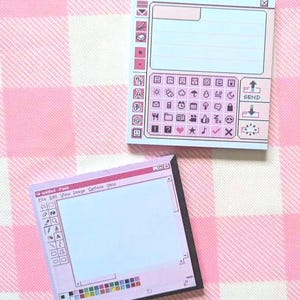 May include: Two square sticky note pads featuring retro computer interface designs. One pad displays a messaging interface with icons and a send button. The other pad shows a paint programme window with a toolbar, colour palette, and the text untitled - Paint.