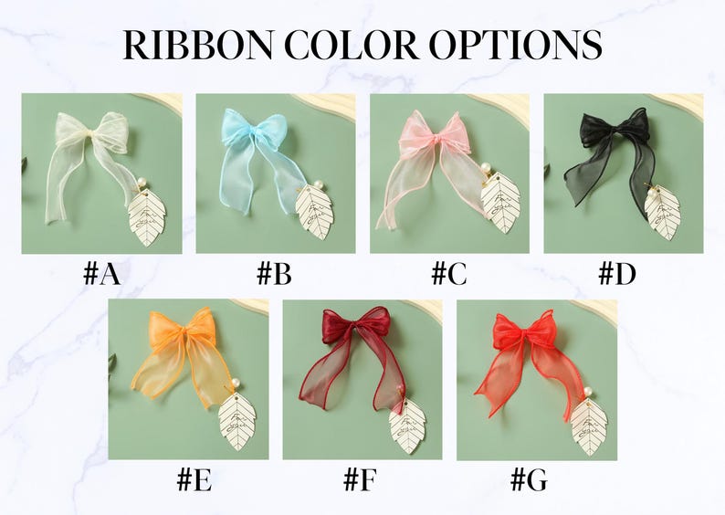 May include: Ribbon color options are displayed, showcasing seven different sheer ribbon bows. Each bow is paired with a leaf-shaped charm and a pearl. The bows come in various colors, including white, blue, pink, black, orange, burgundy, and red.