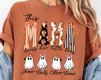 May include: Burnt orange t-shirt with the text "This Mama loves her little boos." The word "MAMA" is designed with dog and pumpkin graphics. Below are four ghost illustrations with names. A personalized Halloween-themed shirt.