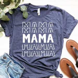 May include: A navy blue t-shirt with the word "MAMA" repeated in white text. The text is in a bold, blocky font.