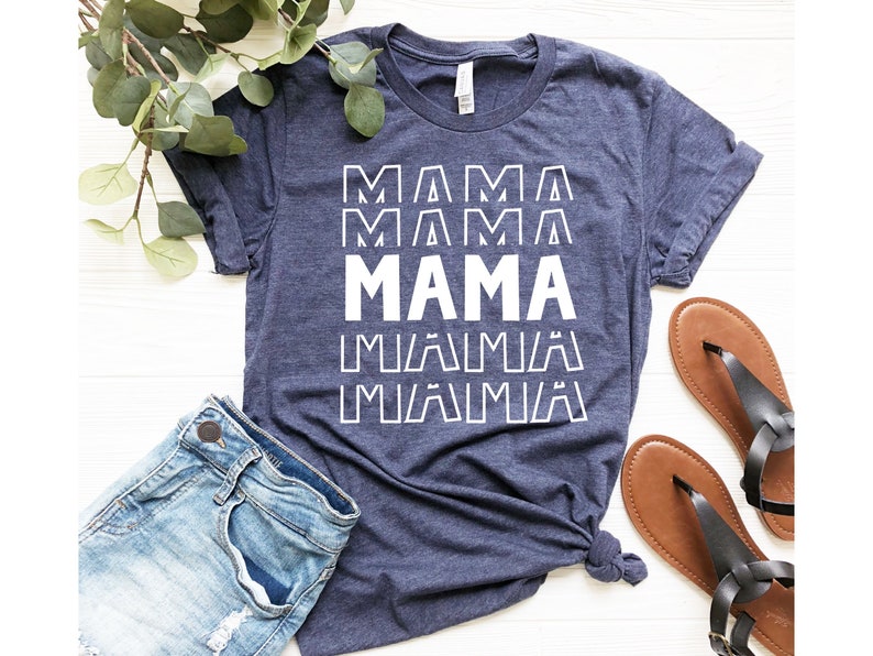 May include: A navy blue t-shirt with the word "MAMA" repeated in white text. The text is in a bold, blocky font.