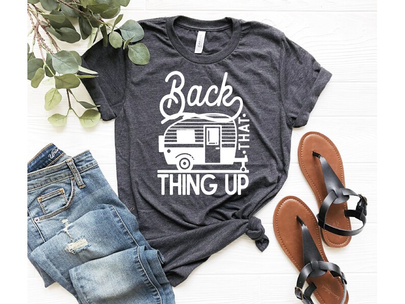 May include: A dark gray t-shirt with a white graphic of a camper and the text "Back that thing up".