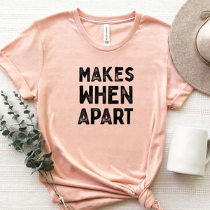 May include: A peach-colored t-shirt with the text "MAKES WHEN APART" printed in black.