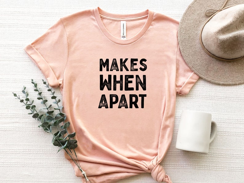 May include: A peach-colored t-shirt with the text "MAKES WHEN APART" printed in black.