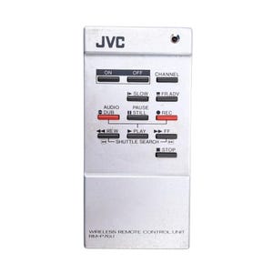 May include: Silver JVC wireless remote control unit, model RM-P76U, with multiple buttons for various functions. Buttons include power, channel, play, pause, rewind, fast forward, and record. The JVC logo is at the top.