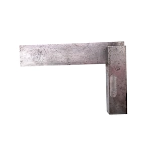 May include: A vintage metal try square, a tool used in woodworking and metalworking. The square has a rectangular blade and a thicker, perpendicular base. The metal has a worn, aged appearance, with visible scratches and wear marks.