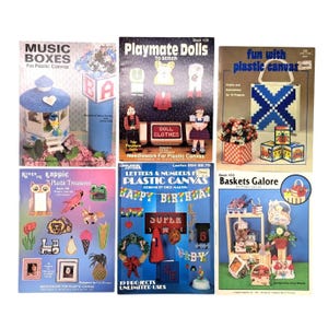 May include: A collection of six instructional craft booklets for plastic canvas projects, featuring titles such as Music Boxes, Playmate Dolls, Fun with Plastic Canvas, Plastic Treasures, Letters & Numbers, and Baskets Galore, with colorful illustrations.