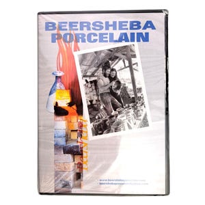 May include: A DVD case titled BEERSHEBA PORCELAIN featuring a blue text header, a graphic of a kiln with orange flames, and a black and white photograph of two people working with pottery. The bottom includes a website and email address.