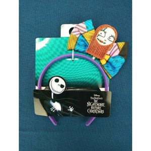 May include: Purple headband with a colourful patchwork bow featuring Sally from Tim Burton's The Nightmare Before Christmas. The bow has a red, blue, yellow, and pink patchwork design with Sally's face in the centre.