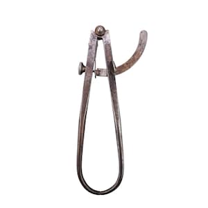 May include: An antique metal caliper tool with a curved arm and a screw adjustment. The tool is made of a dark, aged metal, showing signs of wear. The caliper is designed for measuring the internal or external dimensions of an object.