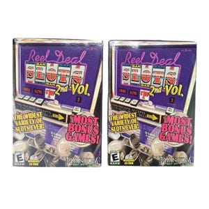 May include: Two identical rectangular boxes for the Reel Deal Slots 2nd Vol. PC game. The purple packaging features a slot machine graphic with the text Reel Deal Slots 2nd Vol., The Widest Variety of Slots Ever!, and Most Bonus Games!.