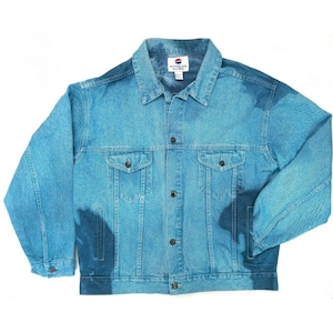 May include: Light blue denim jacket with a classic design. Features a button-up front, two chest pockets, and two side pockets. The jacket has a collar and long sleeves. The label on the back of the collar reads "NOTHING BUT BASICS".