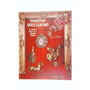 May include: A vintage book cover titled "Simplified Gold Leafing" with a red background and gold-colored decorative elements. The cover features a framed display of gold-leafed objects, including a horse, rooster, and bottle.