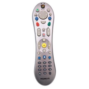 May include: Silver Humax remote control with numerous buttons for TV functions. Features buttons for volume, channel, and DVD control, along with a central navigation pad. The remote has a curved design and the brand name "HUMAX" is printed at the bottom.