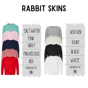 May include: A selection of crewneck sweatshirts in shades like pink, navy, and red. The image features the text "RABBIT SKINS". Each sweatshirt is labelled with a colour name, including "Saltwater" and "Heather". The brand name "THREADSBYTAY" is visible.