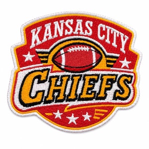 May include: An embroidered patch featuring the text KANSAS CITY CHIEFS in white and yellow with black outlines. The design includes a red football graphic, three white stars at the bottom, two white stars on the sides, and a red background.