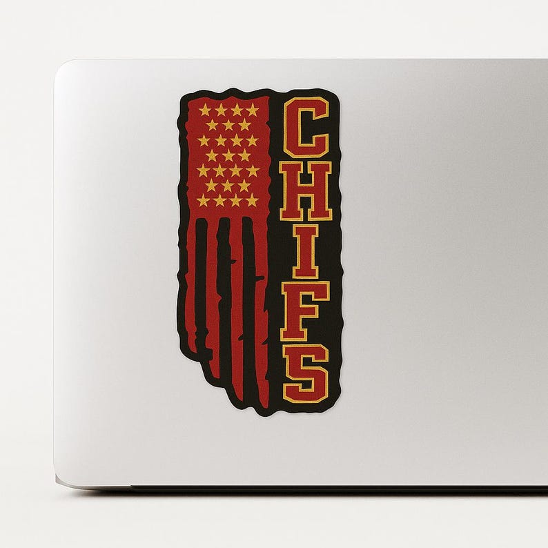 May include: A sticker featuring the word "CHIEFS" in gold, stacked vertically. The left side of the sticker is a red, white, and gold design resembling a flag. The top left corner has gold stars.