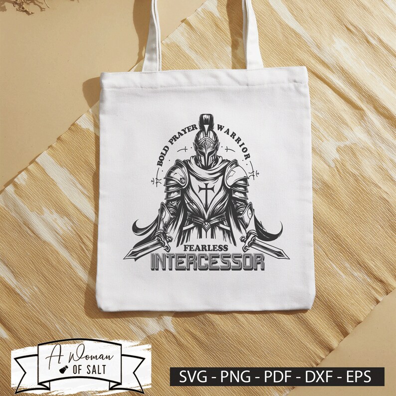 May include: A white tote bag with a black and white illustration of a knight holding a sword. The text "BOLD PRAYER WARRIOR FEARLESS INTERCESSOR" is printed on the bag.